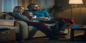 a family watching tv on the couch
