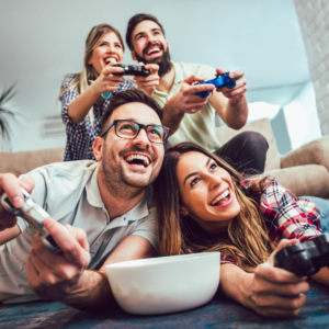 image of four friends with gaming controllers enjoying a fun time